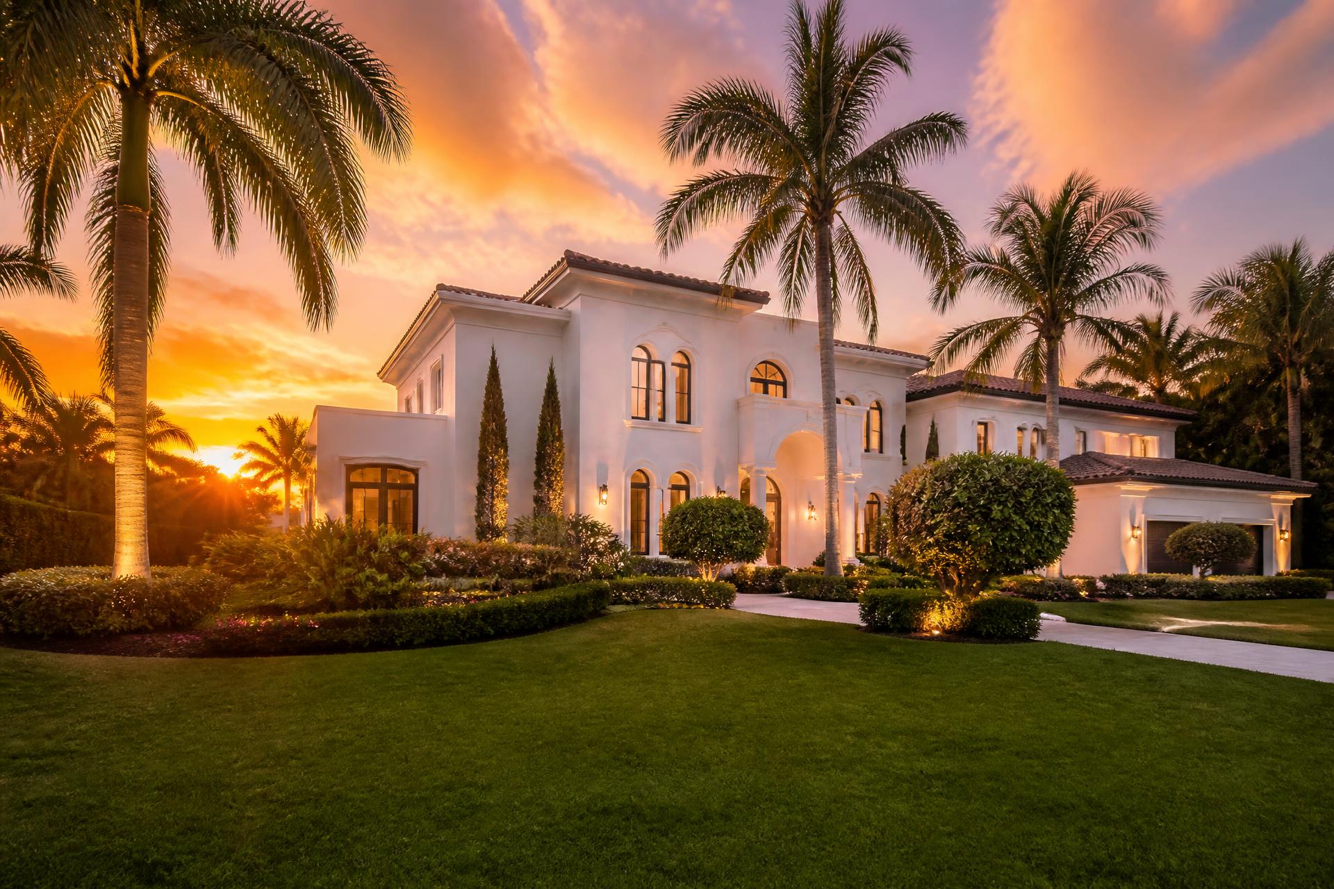 Luxury estate exterior painted white at sunset